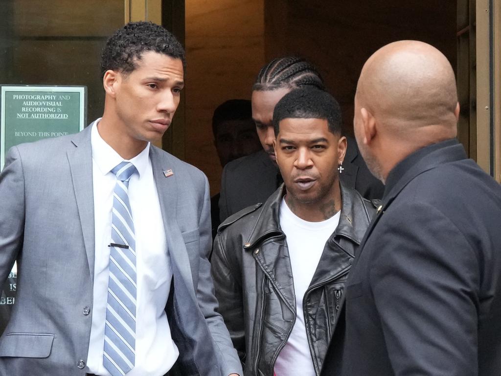 Rapper Kid Cudi (C) leaves the federal court after appearing at the Sean 