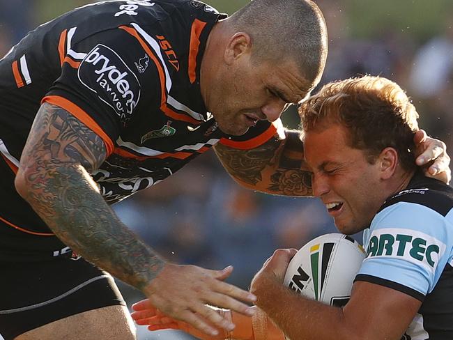 Russell Packer of the Tigers (left) tackles Matt Moylan of the Sharks during the NRL pre-season match between the Cronulla-Sutherland Sharks and the Wests Tigers at Campbelltown Stadium in Sydney, Saturday, February 24, 2018. (AAP Image/Daniel Munoz) NO ARCHIVING, EDITORIAL USE ONLY