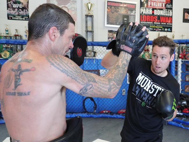 Supercar driver Cam Waters (black shirt) sparring with Gold Coast boxing legend John Wayne Parr at his gym at West Burleigh. Picture Glenn Hampson