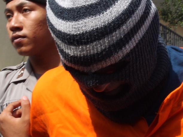 Australian Guiseppe Serafino escorted by Police during press conference of his case at Denpasar Police Station in Bali. Guiseppe was arrested in Sanur with his friend a British man David Matthew possesing hassish.