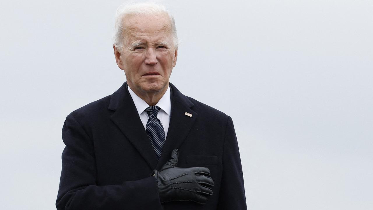 Biden places his hand on his heart during the dignified transfer. Picture: Kevin Dietsch/ Getty Images