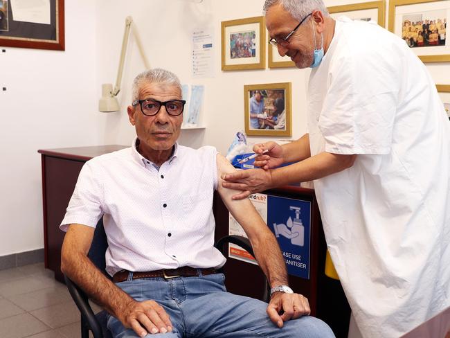 Dr Jamal Rifi administers the AstraZeneca vaccine to Abdul Ghazal 71. Picture: Tim Hunter