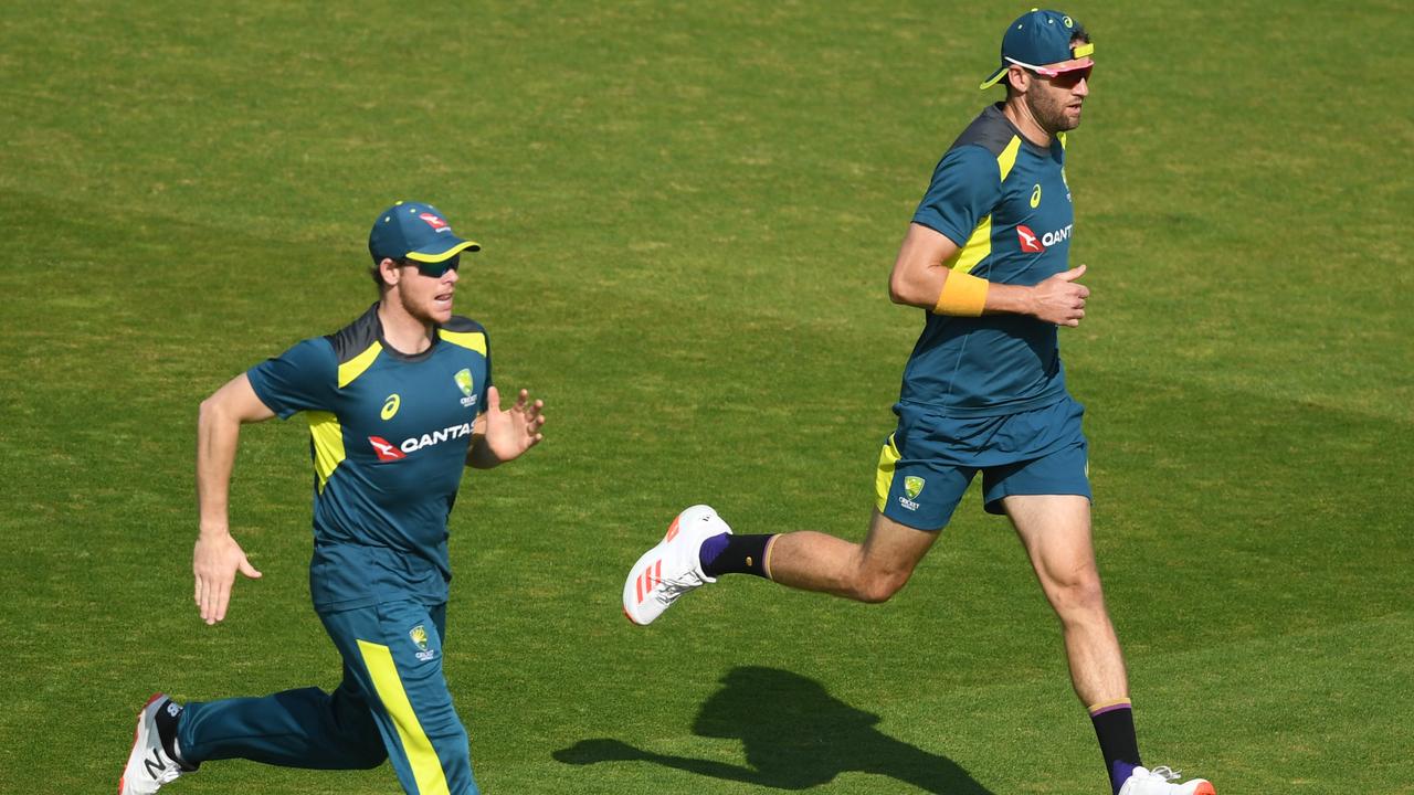 Steve Smith (left) and Andrew Tye warm up before a net session at Old Trafford. Picture: Getty Images