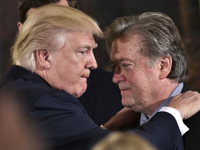 US President Donald Trump (L) congratulates Senior Counselor to the President Stephen Bannon during the swearing-in of senior staff in the East Room of the White House on January 22, 2017. Picture: AP.