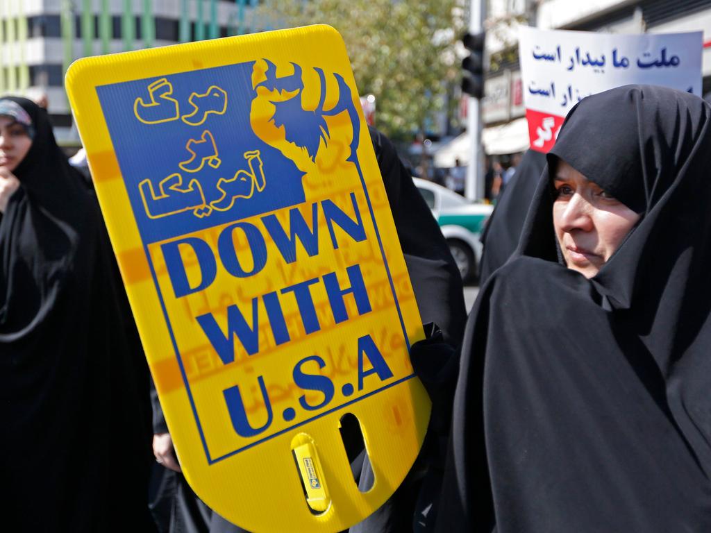 An Iranian woman holds anti-US sign during a demonstration in Tehran on September 28, 2018. The US has cancelled its 63-year-old “friendship” treaty with Iran. Picture: STR/AFP