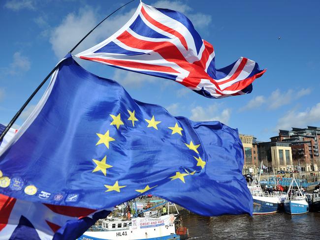 Anti-Brexit activists fly EU flags as fishing boats take part in a demonstration on the River Tyne in Newcastle, northeast England on March 15, 2019, against the terms of the current Brexit deal being offered by Britain's Prime Minister Theresa May. - People working in the fishing industry supported by the pro-Brexit Fishing for Leave organisation, launched a flotilla on Friday in protest against the prospect of Britain continuing to adhere to the EU's Common Fisheries Policy that sets quotas and fishing rights during the transition period after Britain has formally left the European Union. (Photo by Andy Buchanan / AFP)