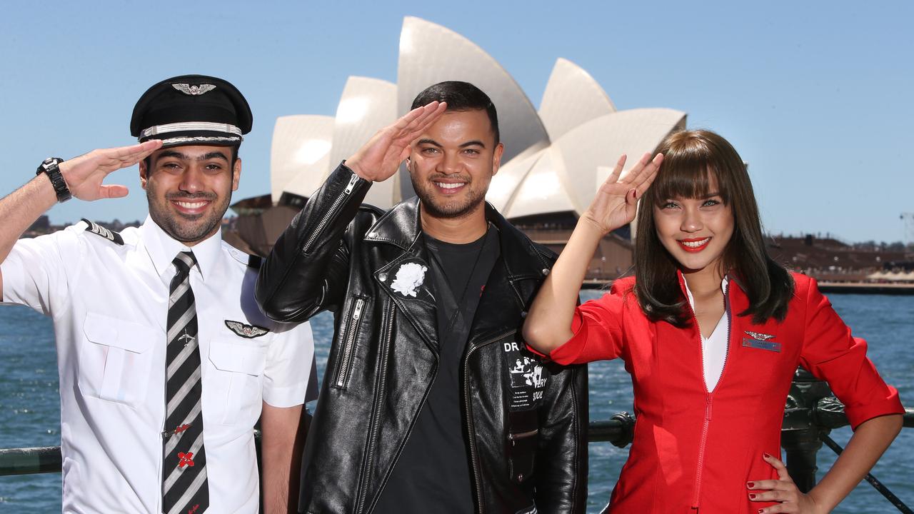 Guy Sebastian with Air Asia staff Mariati Mohd Fikri and Reza Naeimi. Picture Chris Pavlich