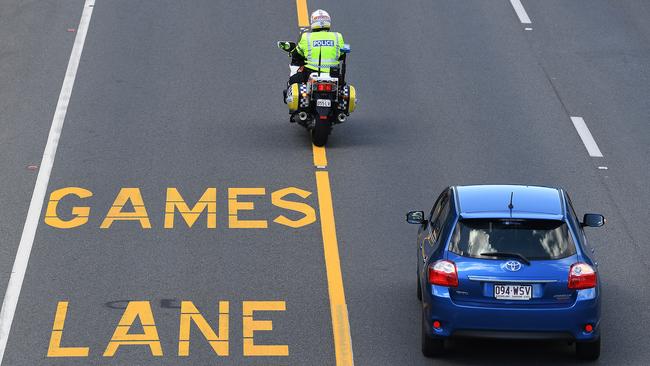 A police officer patrols near a designated Commonwealth Games Lane on the Gold Coast, Wednesday, March 28, 2018. (AAP Image/Dave Hunt)