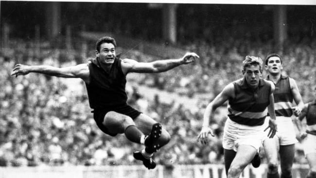 The famous image of Barassi’s kick from the boundary. Picture: Bruce Howard.