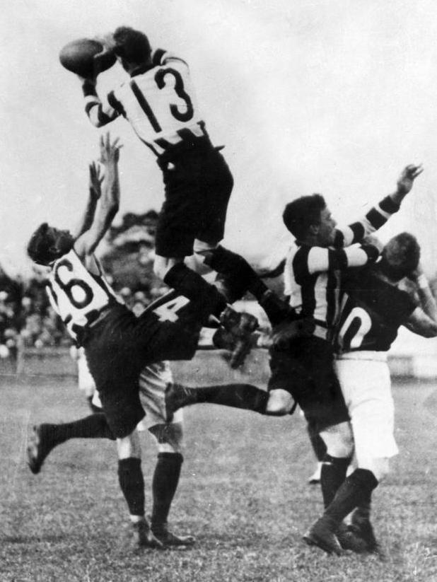 Collingwood's Dick Lee takes a sensational mark.