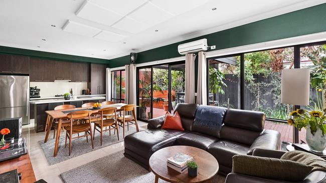 The stylish green living room has plenty of personality.