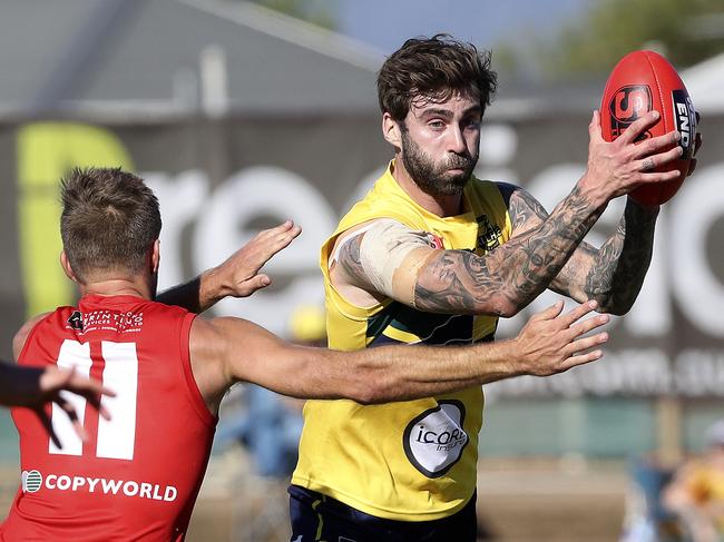 Woodville-West Torrens’ Jack Firns gets away from North Adelaide’s Jarred Allmond. Picture: Sarah Reed