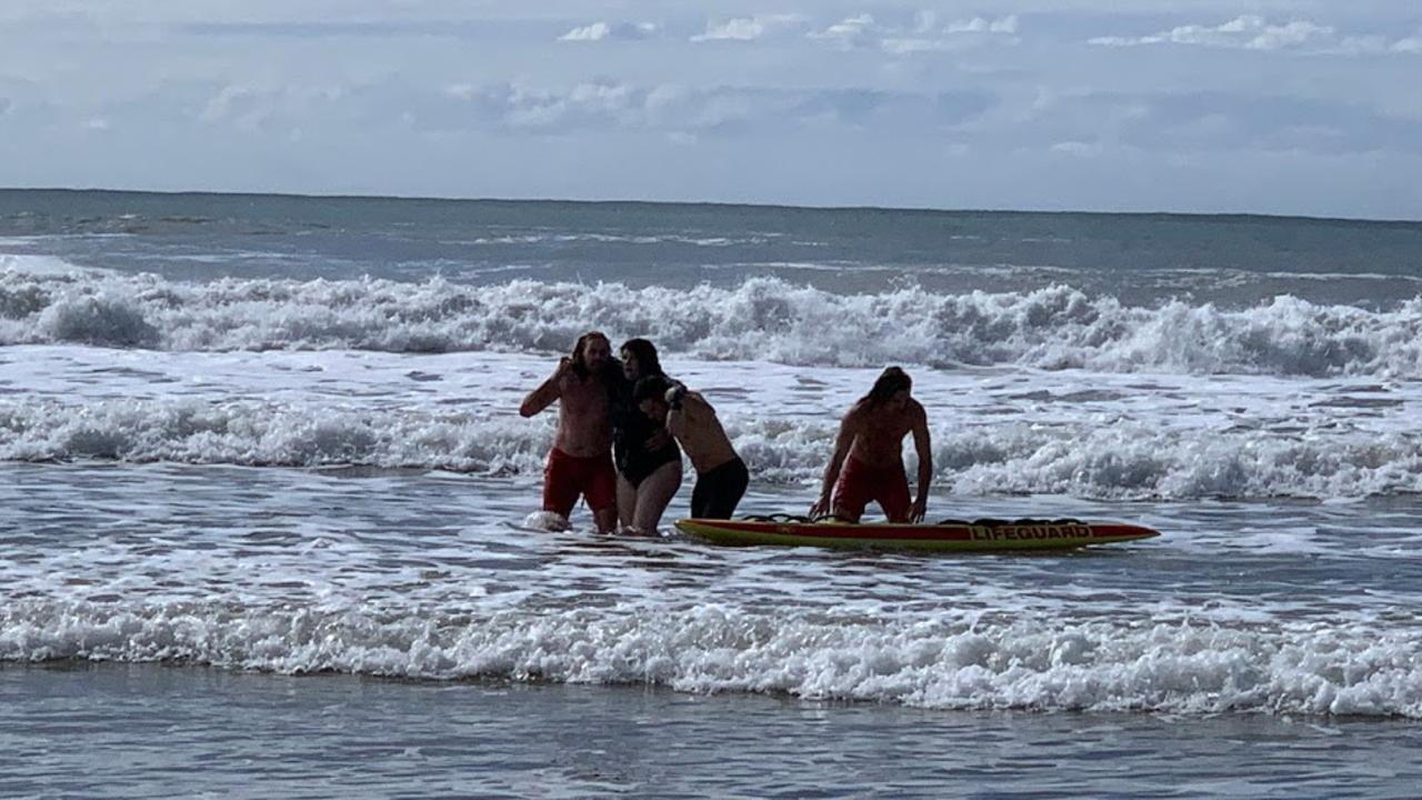 Surf Life Saving Queensland lifeguards rescue Fiona MacDonald from rough surf at Alexandra Headland on Sunday morning. Picture: Stuart Cumming