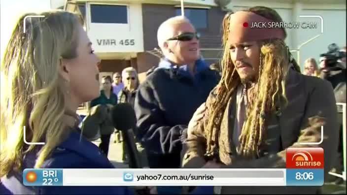 Sunrise reporter Michelle Tapper steals a kiss from Johnny Depp