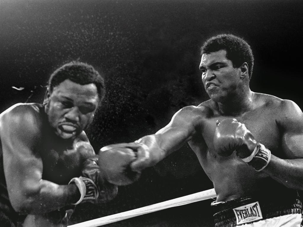 October 1, 1975: Ali lands a right on Joe Frazier during the ninth round of their title fight in Manila, Philippines.