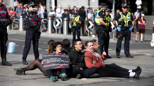 Animal activists stage a sit-down protest in the Melbourne CBD on Monday.