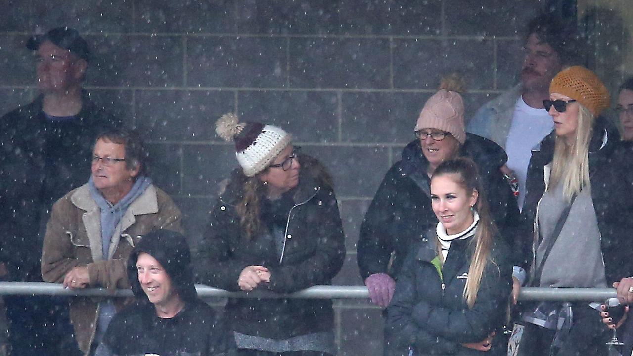 Fans take cover during the Bellarine Football League game between Ocean Grove and Anglesea. Picture: Glenn Ferguson.