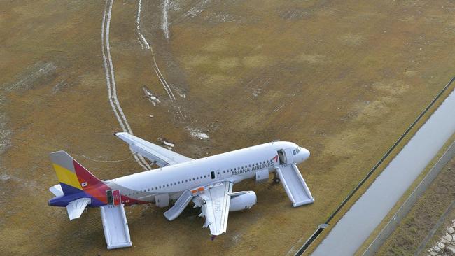 An Asiana Airlines plane sits at Hiroshima airport in Mihara, Hiroshima prefecture, western Japan Wednesday, April 15, 2015 after it skidded off a runway Tuesday. About 20 people received minor injuries, officials said. (Muneyuki Tomari/Kyodo News via AP) JAPAN OUT, MANDATORY CREDIT