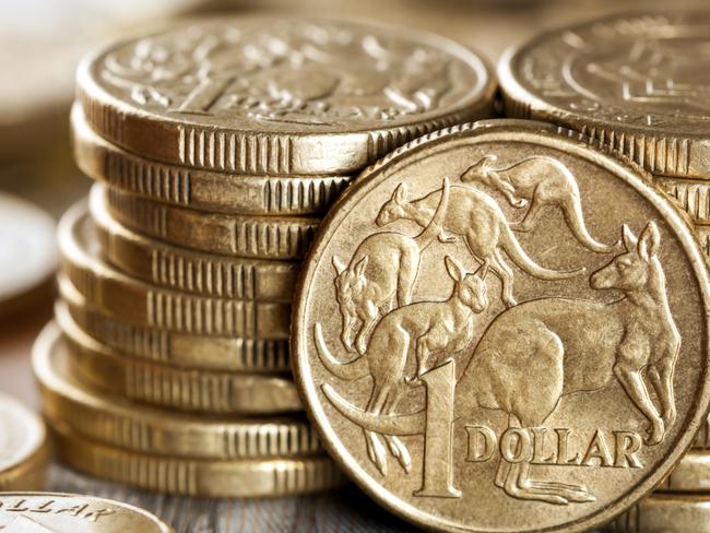 Stacks of Australian one dollar coins. Focus on front coin.