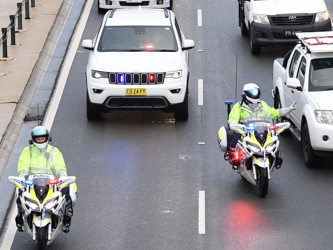 The motorcade carrying Britain's Prince Harry, the Duke of Sussex and his wife Meghan, the Duchess of Sussex makes its way through peak hour traffic on the Eastern Distributor in Sydney, Australia, Tuesday, October 16, 2018. The Duke and Duchess of Sussex are on a 3-week tour of Australia, New Zealand, Tonga, and Fiji and are in Sydney to launch the 2018 Invictus Games, an Olympic-style event for disabled and ill service people. (AAP Image/Dean Lewins) NO ARCHIVING