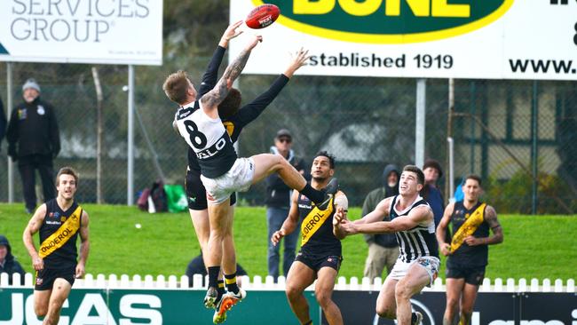 Port Adelaide’s Hamish Hartlett and Glenelg’s Lachlan Hosie contest the ball. Picture: AAP/Brenton Edwards