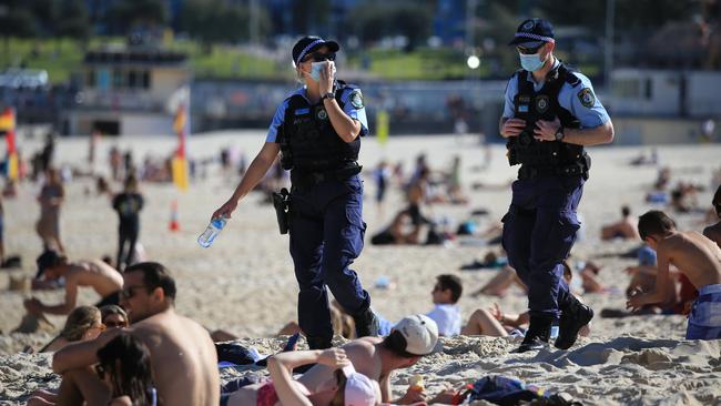 Police patrol a crowded Bondi beach on a warm winter Wednesday in Sydney. Picture: Christian Gilles