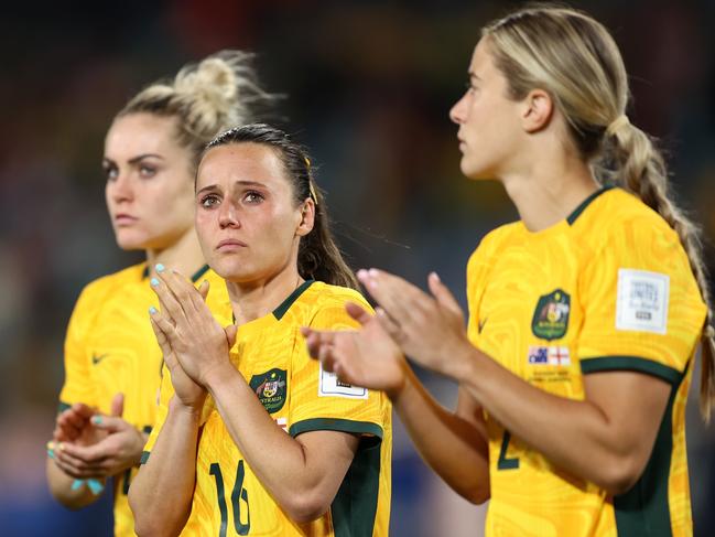 SYDNEY, AUSTRALIA - AUGUST 16: Hayley Raso (C) and Australia players applaud fans after the team's 1-3 defeat and elimination from the tournament following the FIFA Women's World Cup Australia & New Zealand 2023 Semi Final match between Australia and England at Stadium Australia on August 16, 2023 in Sydney, Australia. (Photo by Brendon Thorne/Getty Images)