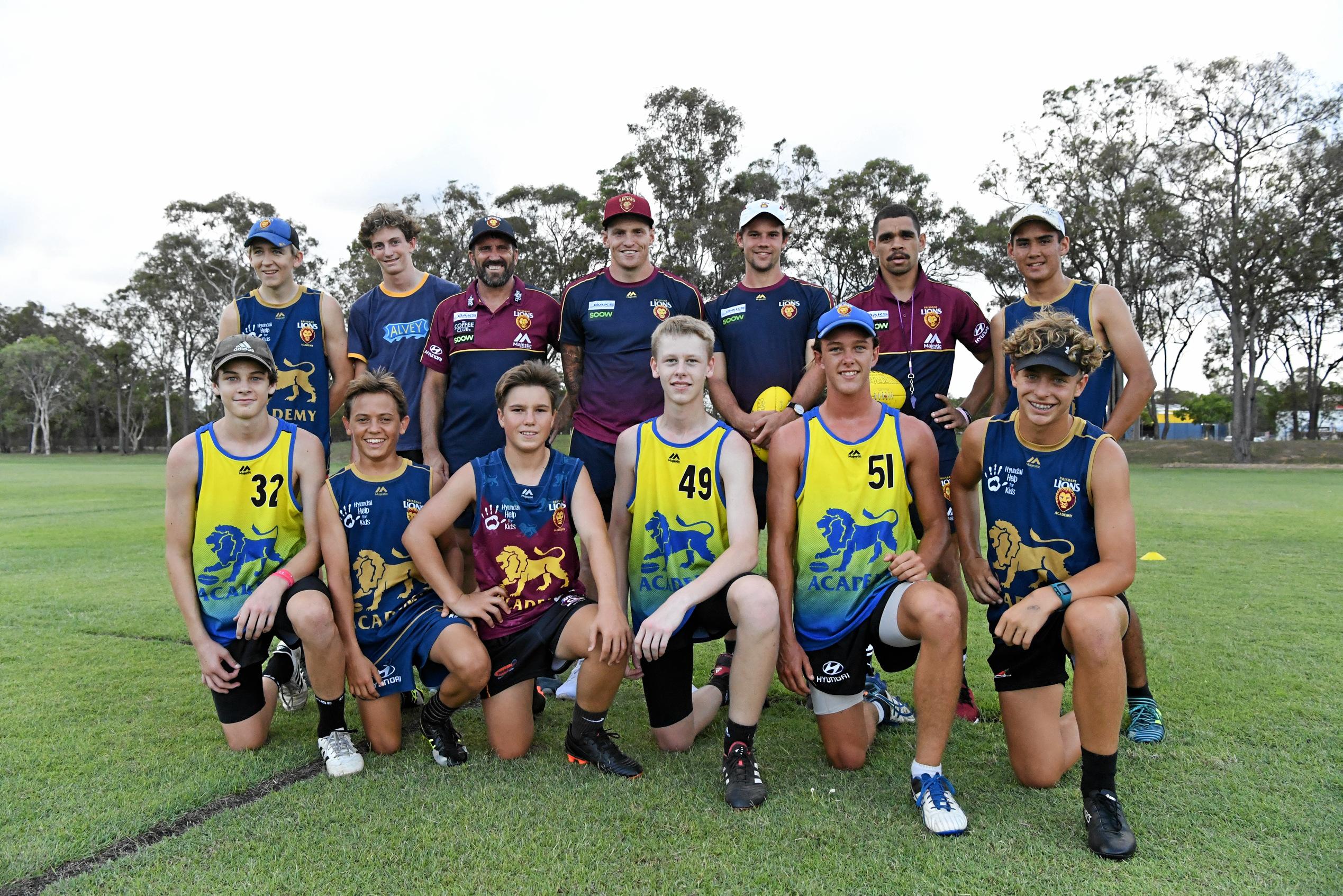 Owen Collins (top left), Ben Wood, Brisbane Lions assistant coach Dale Tapping, Lion Mitch Robinson, Brisbane player Corey Lyons, Lions player Charlie Cameron, Trent Burchard with Harry Hodgson (front left), Harry Schneider, Max Harlacz, Zak Mercieca, Mason Gates and Will Zahn enjoy the Shalom College clinic on Monday. Picture: Shane Jones