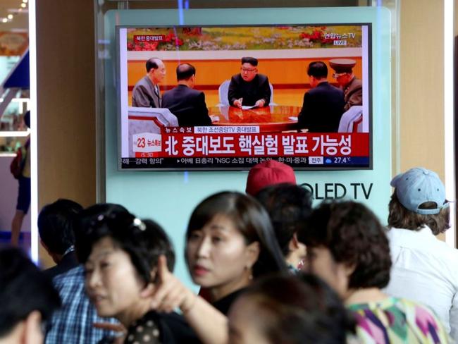 People watch a TV news program showing North Korean leader Kim Jong Un at the Seoul Railway Station in Seoul. Picture: AP / Ahn Young-joon