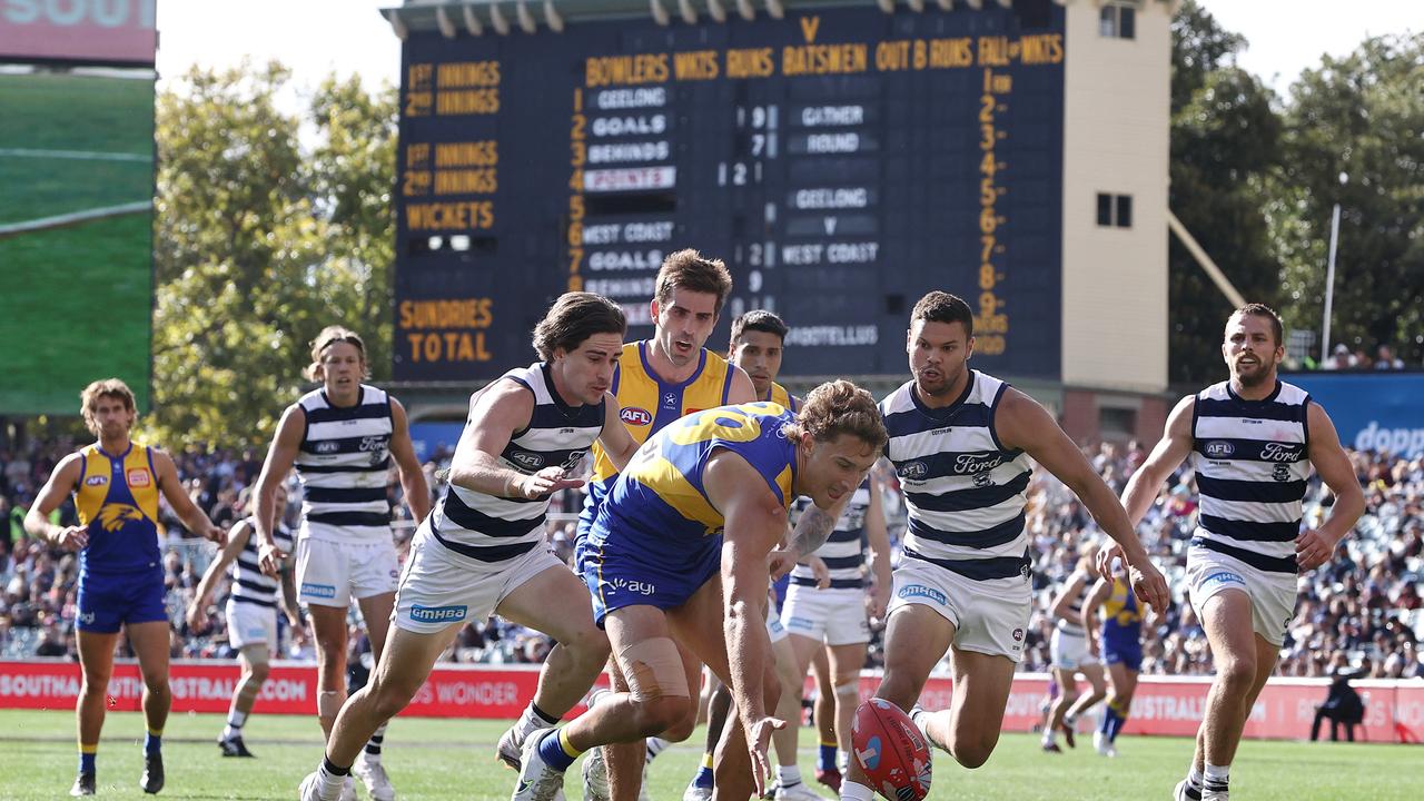 West Coast and Geelong players in front of the iconic Adelaide scoreboard. Pic: Michael Klein.