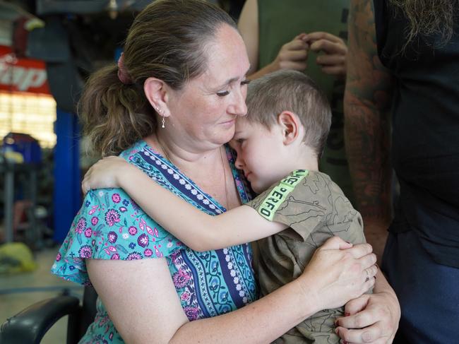 Mum Melanie and little Zacharia, 6, share a moment as they hang out at dad’s workshop, where they used to live together as a family of 12. Picture: Heidi Petith