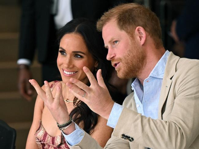 Britain's Prince Harry (R), Duke of Sussex, speaks with his wife Meghan Markle while attending a show during a visit to the National Centre for the Arts in Bogota on August 15, 2024. Picture: Raul Arboleda/AFP