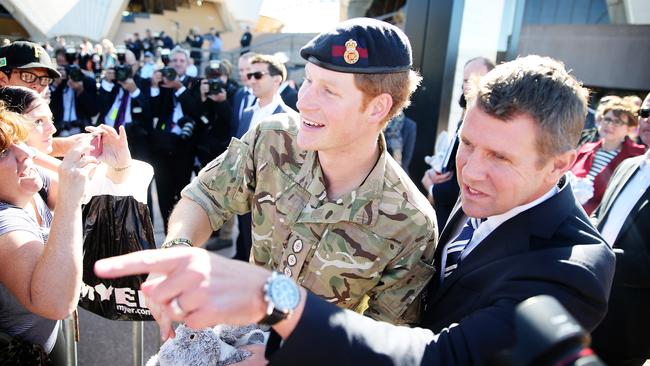 Premier Mike Baird points out friendly faces in the crowd to Prince Harry. Picture: Craig Greenhill