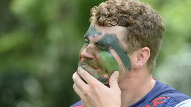 Lachlan Currie applying camouflage during a Gold Coast Cyclones photoshoot. Picture: Lawrence Pinder