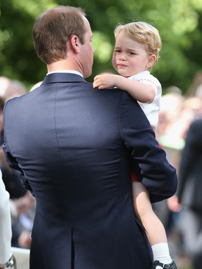 Britain’s Prince William, Duke of Cambridge and Prince George of Cambridge leave Princess Charlotte of Cambridge’s Christening at St. Mary Magdalene Church in Sandringham, England, on July 5, 2015. Picture: AFP