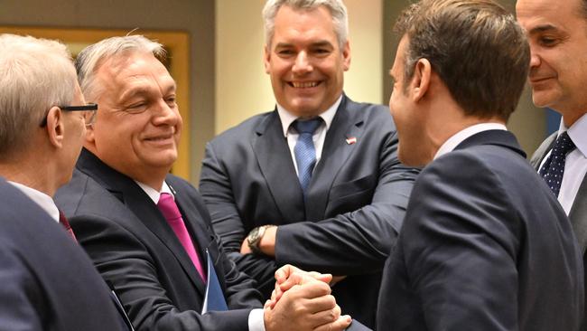 Hungarian Prime Minister Viktor Orban, left, and France's President Emmanuel Macron shake hands before the meeting of the European Council in Brussels on Friday. Picture: AFP