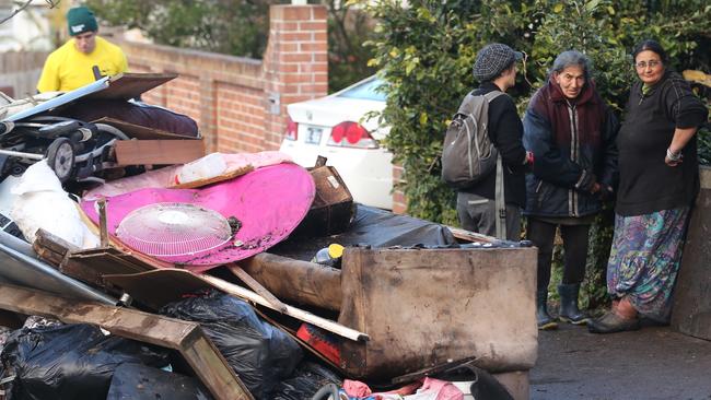 Mary Bobolas, and her daughters Elena and Liana, pictured after being forcibly removed by police from their Bondi ‘hoarder house’ during a clean up Picture: John Grainger