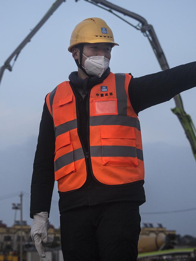 A construction worker supervising a new hospital being built in Wuhan. Picture: Getty