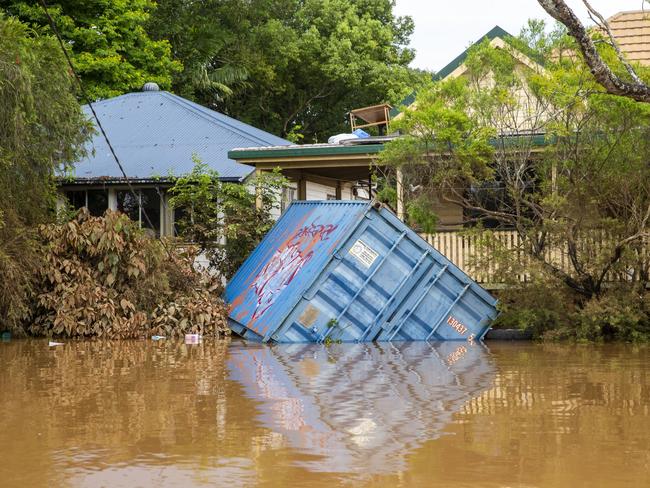 A shipping contain washes up on a front lawn in Lismore on March 1, 2022.