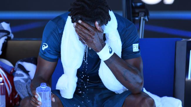 Gael Monfils struggles in the Melbourne heat.