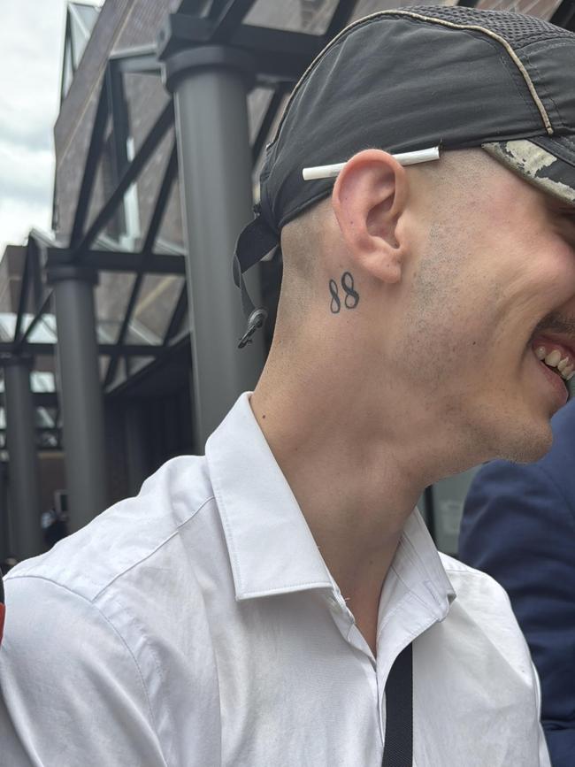 A Nazi-symbol tattooed under the ear of Christopher Carrig.