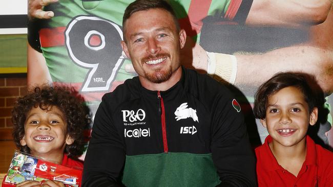 Darlington Public School students Ditchu Winters, 7, and Kian Walhers, 8, meet South Sydney Rabbitohs player Damien Cook on Wednesday. Picture: John Appleyard