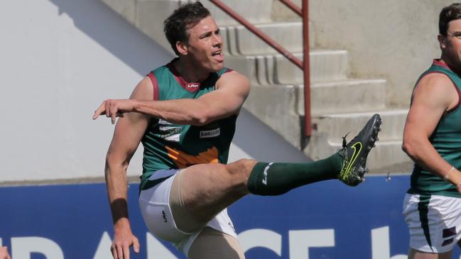 Tasmania's Matthew Richardson has a shot on goal in his Tassie jumper.