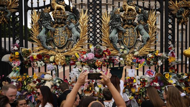 People gather at the gates of Buckingham Palace in London on Sunday. Picture: Getty Images