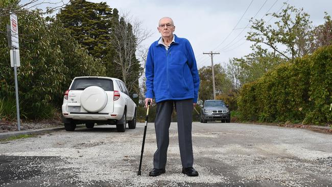 Retiree Hugh Livingstone says dangerous loose stones create a slipping hazard on a footpath near his home. Picture: Josie Hayden