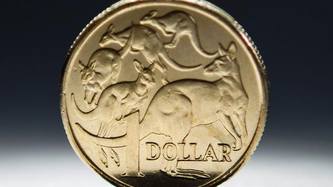 An Australian one-dollar coin is arranged for a photograph in Sydney, Australia, on Wednesday, April 17, 2013. Direct trading between the Australian dollar and yuan started on April 10. Photographer: Ian Waldie/Bloomberg