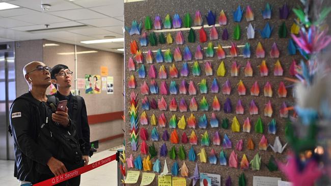 Paper cranes are placed on a wall outside the intensive care unit treating Alex Chow, who died on Friday. Picture: AFP