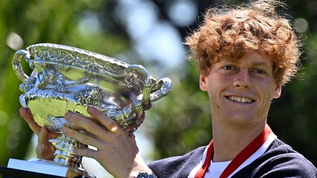 Italy's Jannik Sinner poses with the Norman Brookes Challenge Cup trophy at the Royal Botanic Gardens.