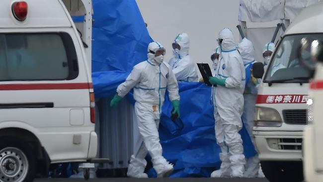 Medical staff clad in protective gear prepare to provide care for suspected coronavirus patients onboard the quarantined Diamond Princess cruise ship at Daikoku Pier Cruise Terminal in Yokohama. (Photo by Kazuhiro NOGI / AFP)