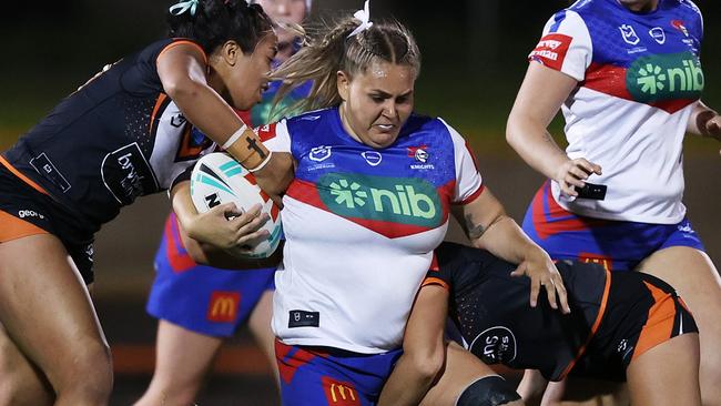 SYDNEY, AUSTRALIA - SEPTEMBER 14: Caitlan Johnston of the Knights is tackled during the round nine NRLW match between Wests Tigers and Newcastle Knights at Leichhardt Oval, on September 14, 2023, in Sydney, Australia. (Photo by Mark Metcalfe/Getty Images)